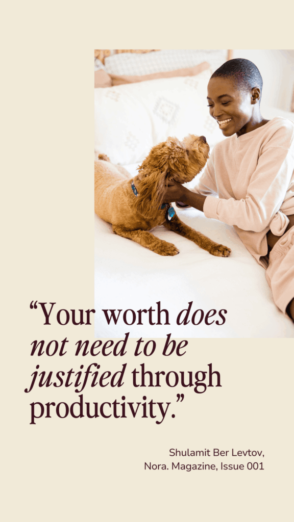 A smiling person in a soft pink outfit is lying on a bed, joyfully interacting with a fluffy dog. The text reads, "Your worth does not need to be justified through productivity." The tone is warm and comforting.