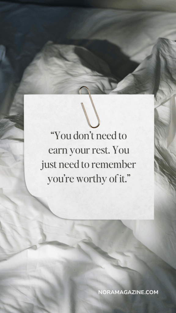 A note paper-clipped to a white, rumpled bedsheet reads, "You don't need to earn your rest. You just need to remember you're worthy of it." The tone is calming and reassuring.